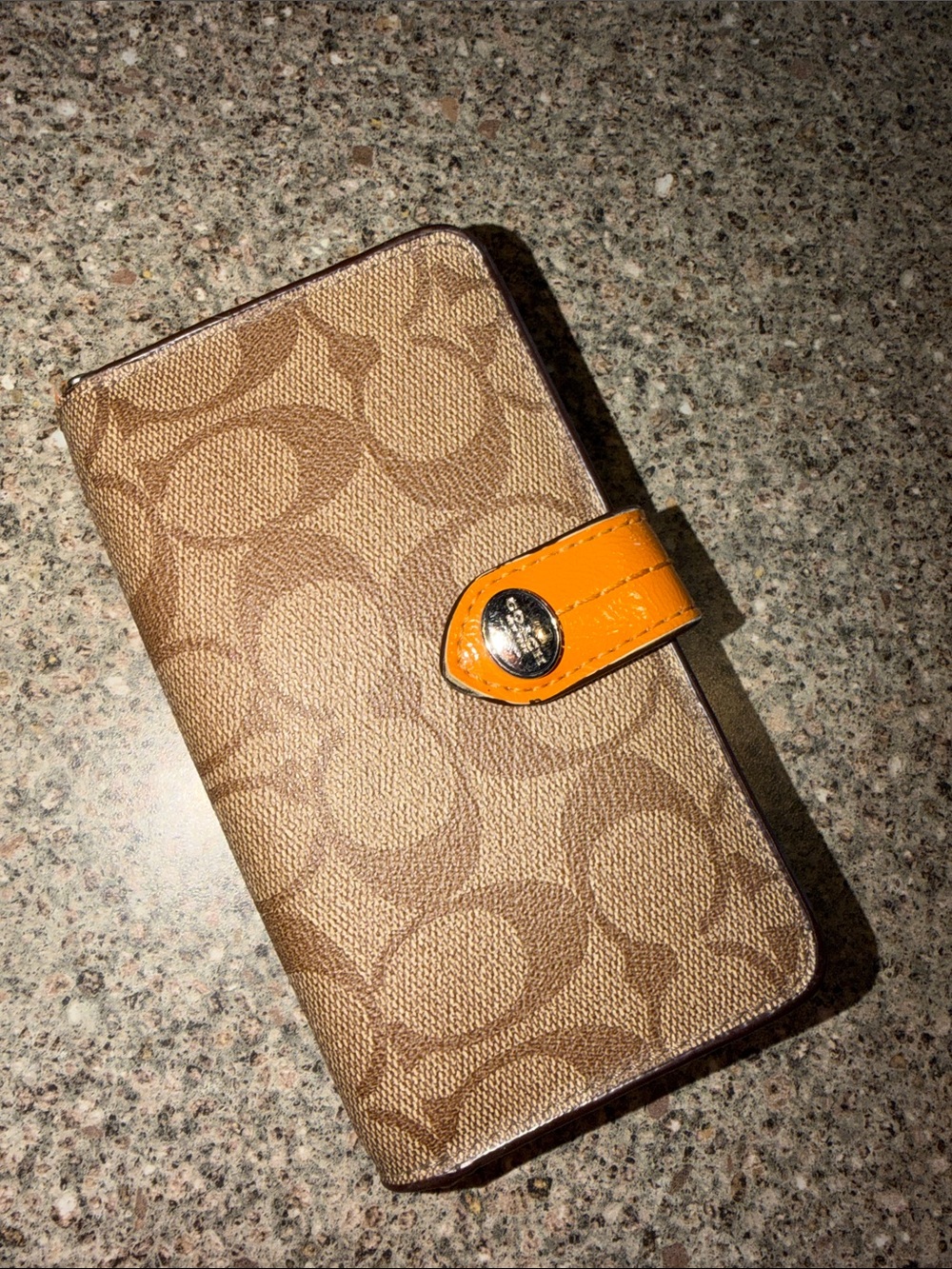 Coach Brown Signature Canvas wallet with orange patent snap